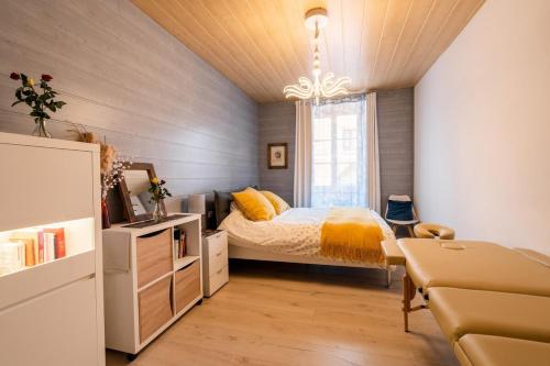 une chambre avec un lit, un bureau et un canapé dans l'établissement Meublé de tourisme 4 étoiles, Centre historique, à Kaysersberg