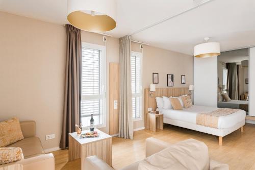 a bedroom with a bed and a living room at Appart hôtel Q7 Lodge Lyon 7 in Lyon