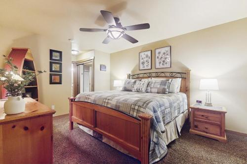 a bedroom with a bed and a ceiling fan at Fireside Escape at Lake Cushman in Hoodsport