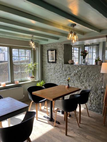 a dining room with a wooden table and chairs at Smugglers Hotel in Brixham