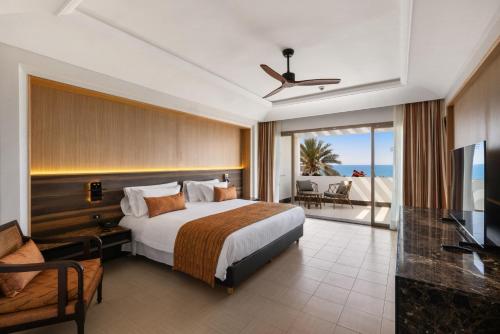 a hotel room with a bed and a television at Hotel Riu Palace Tikida Agadir - All Inclusive in Agadir