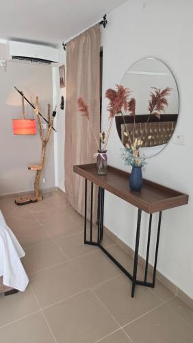 a mirror on top of a table in a room at Appartements de luxe près de la mer in Nabeul