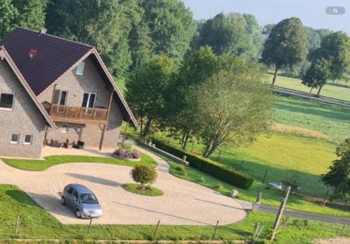 a house with a car parked in a driveway at Apartments Mester in Xanten