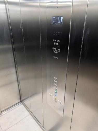 an elevator with a door with a clock on it at Dwupokojowe z osobną kuchnią na osiedlu Przystanek Międzylesie in Warsaw