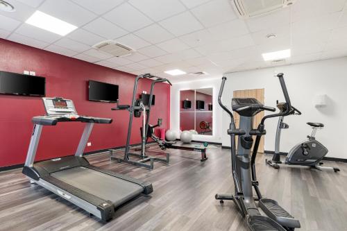 a gym with treadmills and cardio equipment in a room at Appart hôtel Q7 Lodge Lyon 7 in Lyon