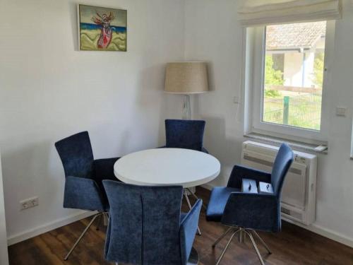 a room with a table and chairs and a window at Haus Wentowseeblick in Zehdenick