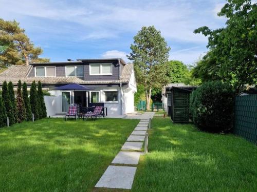 a house with a yard with green grass at Haus Wentowseeblick in Zehdenick