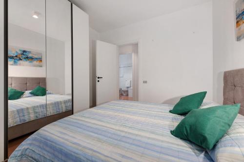 a bedroom with a bed with a large mirror at Domaso front lake in Domaso