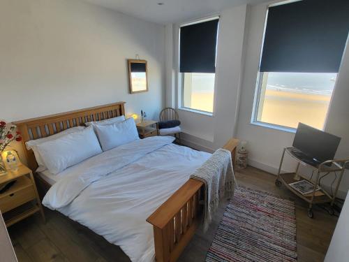 a bedroom with a bed and a desk with a laptop at Imperial House "Serviced Apartments" in Margate