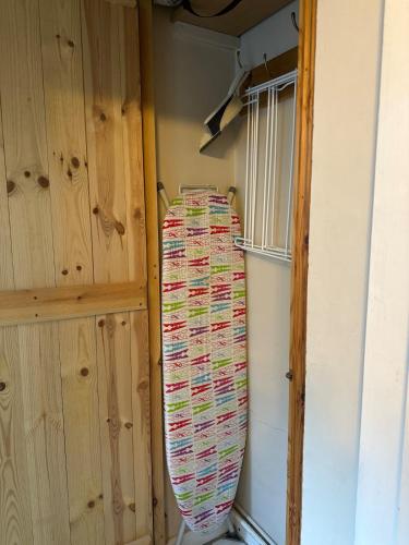 a surfboard hanging on a wall in a room at Valentine Cottage, Aylsham in Aylsham