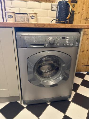 a washing machine under a counter in a kitchen at Valentine Cottage, Aylsham in Aylsham