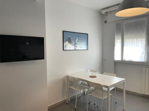 a white dining room with a white table and chairs at Milano Canal Apartments in Milan