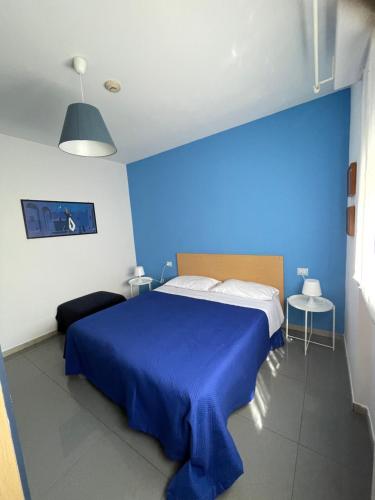 a blue bedroom with a bed with a blue wall at Milano Canal Apartments in Milan
