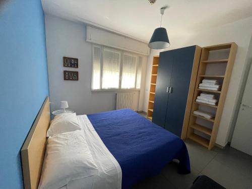 a bedroom with a blue bed and a blue cabinet at Milano Canal Apartments in Milan