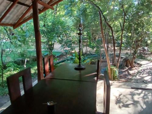 a dining room table with a view of a forest at Villa Habarana in Habarana