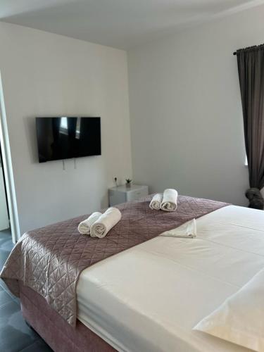 a bedroom with a bed with towels on it at AAA Luxury Suites Split in Split