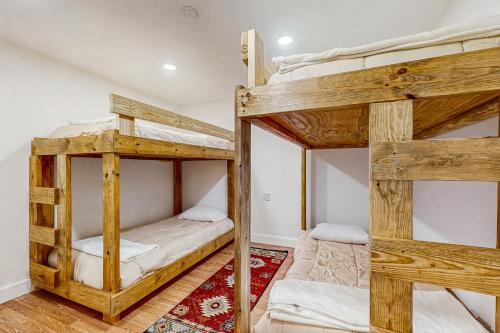 two bunk beds in a room with a rug at Serenity Now in New Tazewell