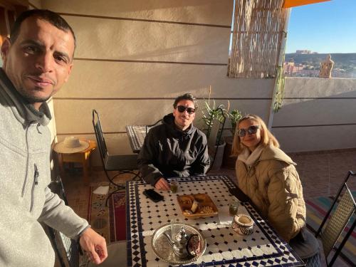 a group of three people sitting at a table at Dar Mgouna Roses in Kalaat MGouna