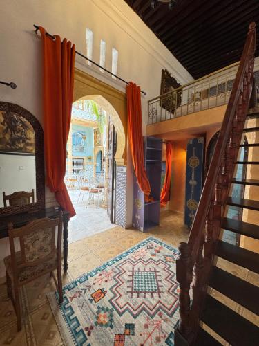 a hallway of a house with a staircase and a rug at RIAD ESMERALDA By Dar Ouezzani in Rabat