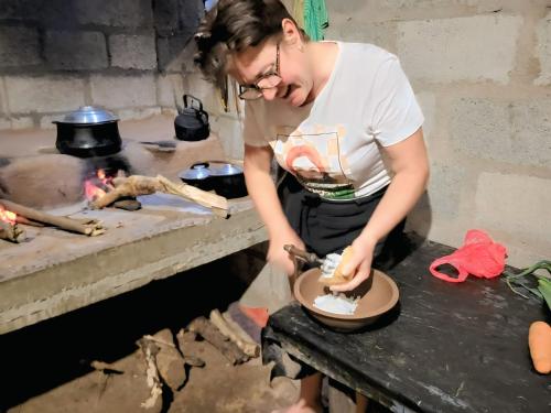 a woman is making a bowl on a table at Relax Nature Villa in Sigiriya