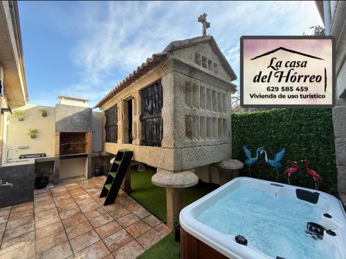 a model of a church with a tub in a yard at La Casa del Horreo in Combarro