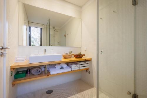 een badkamer met een wastafel en een spiegel bij Laranjal Farm House in Moncarapacho