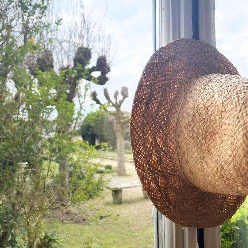 a wicker basket is hanging on a window at Le jardin de L'Hippodrome in Chantilly
