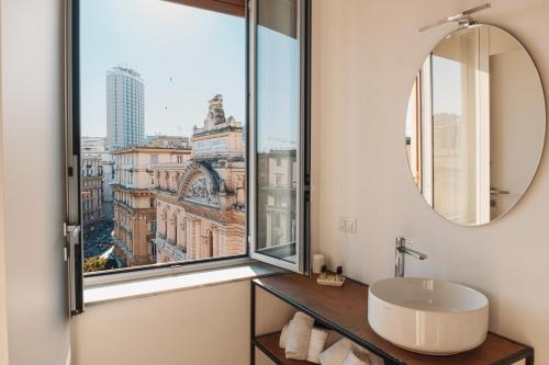 a bathroom with a sink and a large window at ATTICO33 in Naples