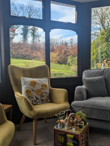 a living room with a chair and a couch at Willowbank House in Enniskillen