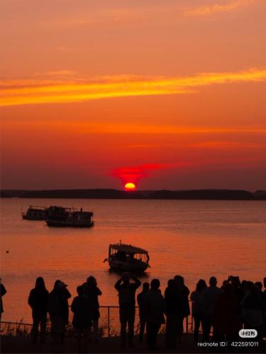 a group of people looking at the sunset at Karma Kono in Abu Simbel