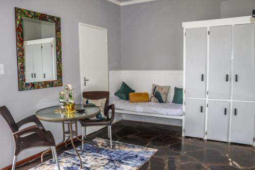 a living room with a table and a couch at Panorama Chalets & Rest Camp in Graskop