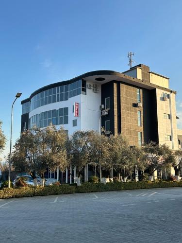 a building with a parking lot in front of it at Luxury Hotel By Gjyshi in Qerrexhias