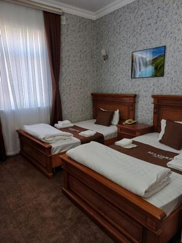Postel nebo postele na pokoji v ubytování Maximum Hotel
