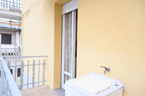 a white sink on a balcony with a window at M423 - Marcelli, comodo trilocale a due passi dal mare in Marcelli
