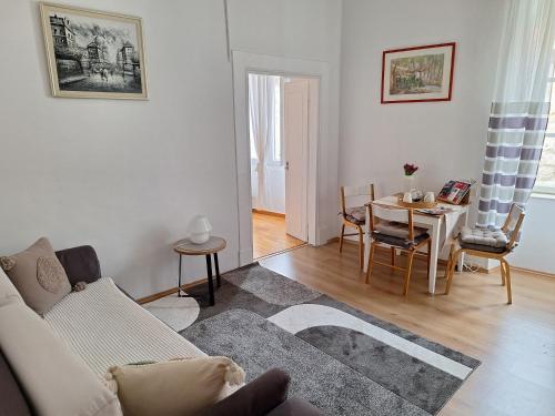 a living room with a couch and a table at Dolce Vita Old Town Studio in Dubrovnik