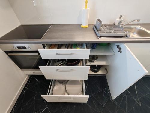 a kitchen with a counter with a sink and a drawer at Studio Hathor - Bikers Welcome in Kranj