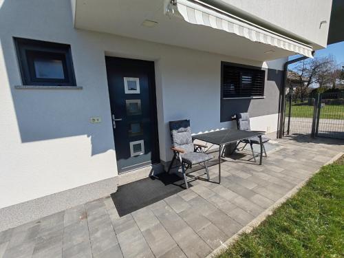 a patio with a table and chairs next to a building at Studio Hathor - Bikers Welcome in Kranj