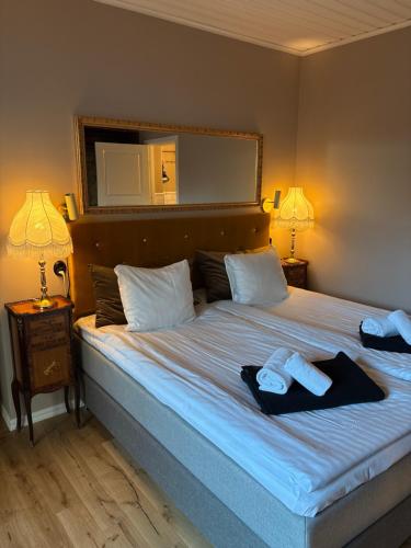 a bedroom with a large bed with two towels on it at Cameo Boutique Hotell in Ystad