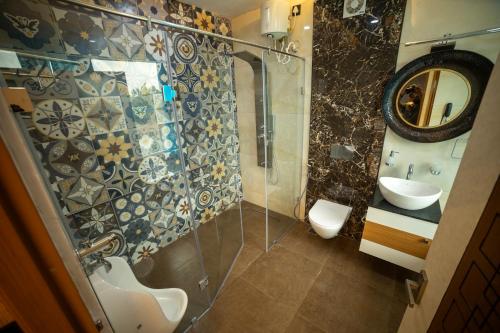 a bathroom with a shower and a sink and a mirror at S Cross Munroe Island Resort in Munroe Island