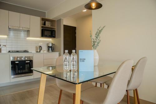 a dining room with a glass table and chairs at Pod by Wynwood House in Lima