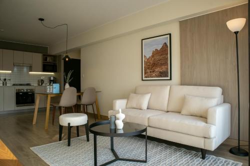 a living room with a white couch and a table at Pod by Wynwood House in Lima