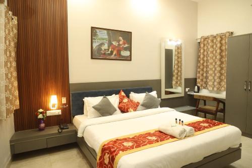 a hotel room with two beds and a mirror at Shiv Hari Mahal in Jodhpur