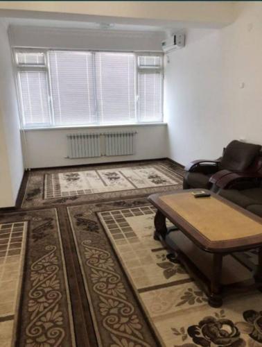 a living room with a couch and a table at Guesthouse in Samarkand