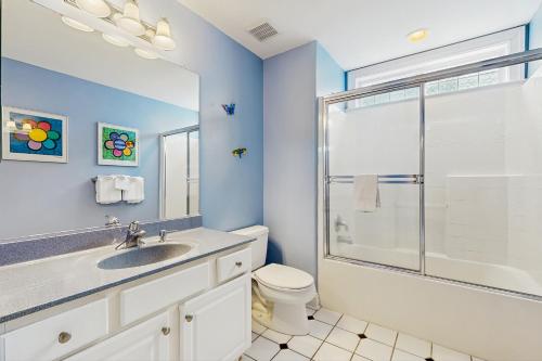 a bathroom with a toilet and a sink and a shower at Heron's Retreat in Ocean City