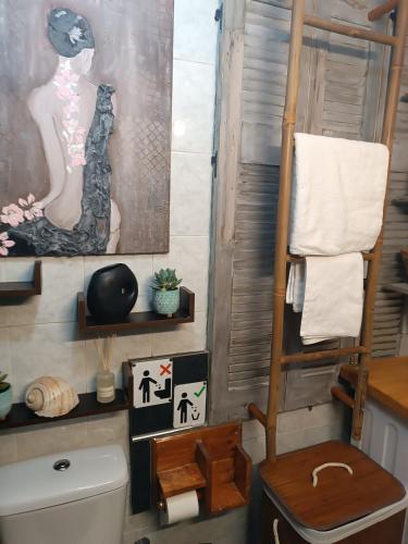 a bathroom with a toilet and a painting on the wall at ΩκεανιςHouse 1 in Preveza