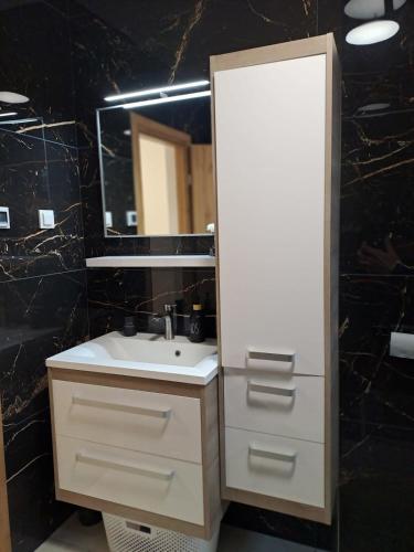 a bathroom with a sink and a mirror at Dedin dvorac in Valpovo