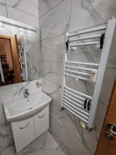a bathroom with a sink and a mirror at Alpine Relax free spa & pool in Pamporovo