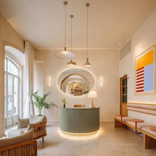 a lobby with a reception desk in the middle of a room at The Verse in Lisbon
