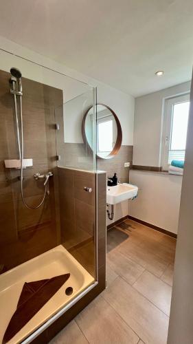 a bathroom with a shower and a sink at Ferienwohnung Nr. 9 in Borkum