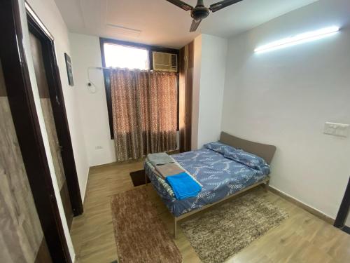 a small room with a bed and a window at 2BHK Stay in Dwarka in New Delhi